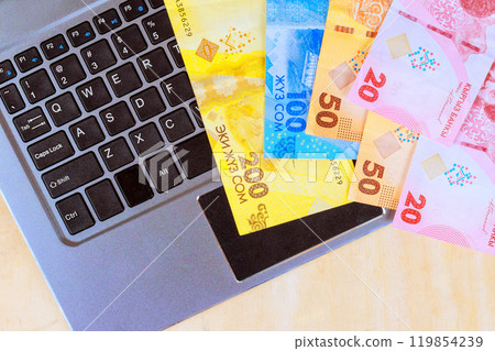 Kyrgyzstan money som various banknotes over keyboard to online payment Kyrgyzstan money som various banknotes over keyboard to online payment 119854239
