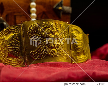 close up shot reproduction of ancient rome golden bracelet with roman eagle decoration close up shot reproduction of ancient rome golden bracelet with roman eagle decoration 119854406