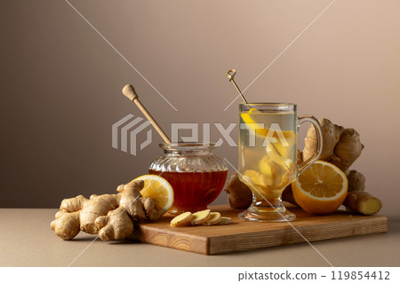Ginger tea with lemon and honey on a beige background. Ginger tea with lemon and honey on a beige background. 119854412