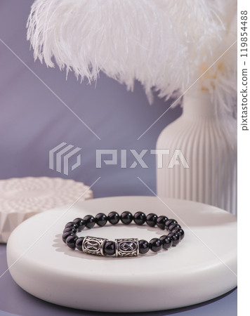 Woman's wrist wearing orange agate bracelet, isolated on white background. Woman's wrist wearing orange agate bracelet, isolated on white background. 119854488