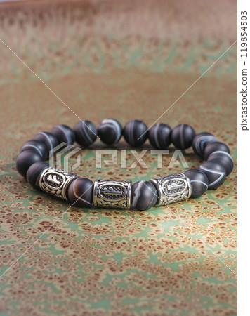 Black Obsidian stone bracelet , Chinese men's modern retro style fashion. Isolated on white background Black Obsidian stone bracelet , Chinese men's modern retro style fashion. Isolated on white background 119854503