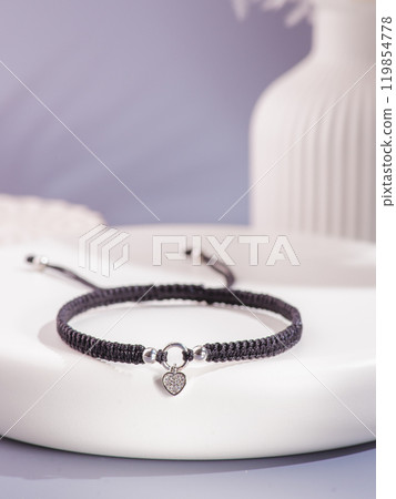 Woman's wrist wearing orange agate bracelet, isolated on white background. Woman's wrist wearing orange agate bracelet, isolated on white background. 119854778