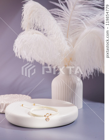 Woman's wrist wearing orange agate bracelet, isolated on white background. Woman's wrist wearing orange agate bracelet, isolated on white background. 119854779
