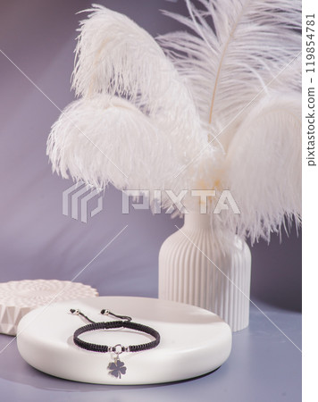 Woman's wrist wearing orange agate bracelet, isolated on white background. Woman's wrist wearing orange agate bracelet, isolated on white background. 119854781