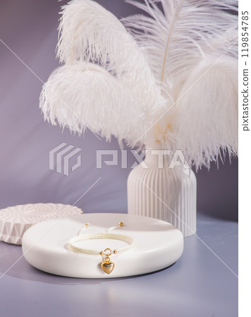 Woman's wrist wearing orange agate bracelet, isolated on white background. 119854785