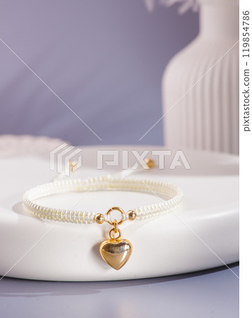 Woman's wrist wearing orange agate bracelet, isolated on white background. 119854786