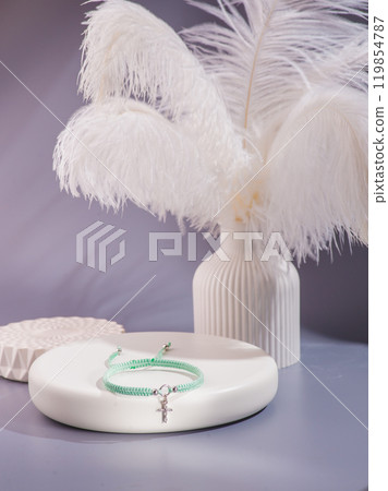 Woman's wrist wearing orange agate bracelet, isolated on white background. 119854787