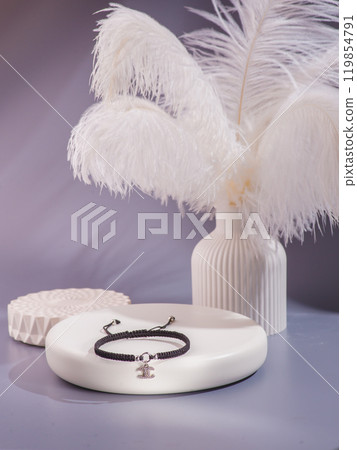 Woman's wrist wearing orange agate bracelet, isolated on white background. 119854791