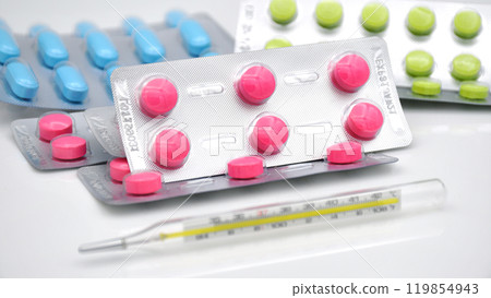 Strips of medicine and the oral thermometer. Strips of medicine and the oral thermometer. 119854943