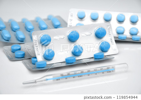 Strips of medicine and the oral thermometer. Strips of medicine and the oral thermometer. 119854944