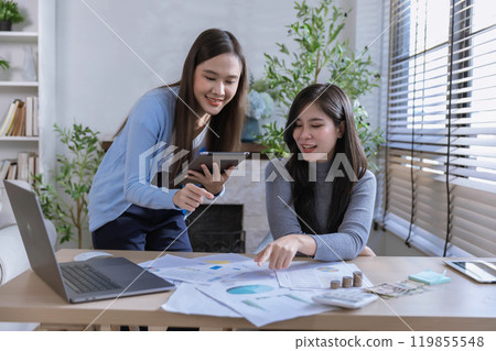 Team of partners Asian business woman discussing project on laptop sitting at table in office. Two colleagues of professional business people working together. 119855548
