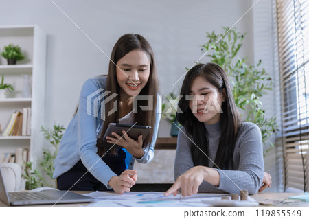 Team of partners Asian business woman discussing project on laptop sitting at table in office. Two colleagues of professional business people working together. 119855549