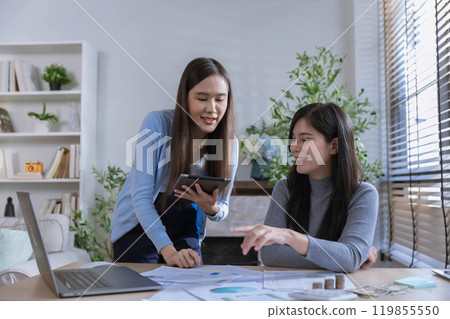 Team of partners Asian business woman discussing project on laptop sitting at table in office. Two colleagues of professional business people working together. 119855550