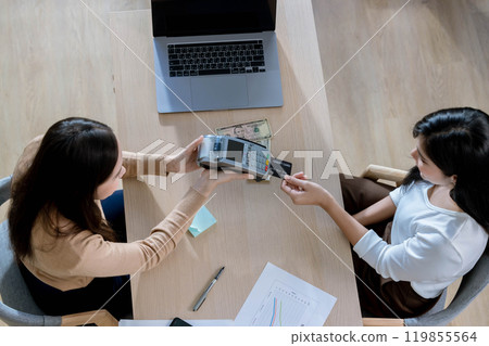 young woman looking at Laptop screen holding credit card, using Laptop secured online e-banking app, satisfied with online cashback purchase or good electronic banking services. 119855564
