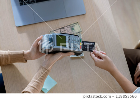 Customer using credit card for payment to receptionist. cashless technology and credit card payment concept. Owner In Retail Shop With Customer Paying Using Payment Credit Card 119855566