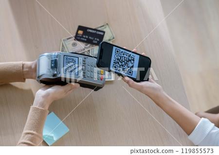 QR code payment, customer using smartphone for paying at shop. Customer paying with qr code on smartphone screen payment technology at shop QR code payment, customer using smartphone for paying at shop. Customer paying with qr code on smartphone screen payment technology at shop 119855573