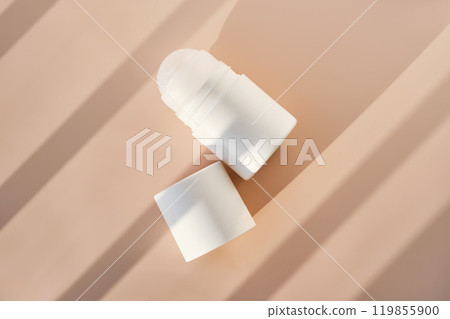 Roll-on deodorant on a purple background with shadow stripes. Roll-on deodorant on a purple background with shadow stripes. 119855900