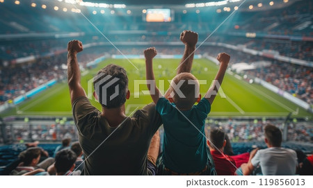 Father and son Cheering at football match, Family celebrating goal in stadium stands Father and son Cheering at football match, Family celebrating goal in stadium stands 119856013