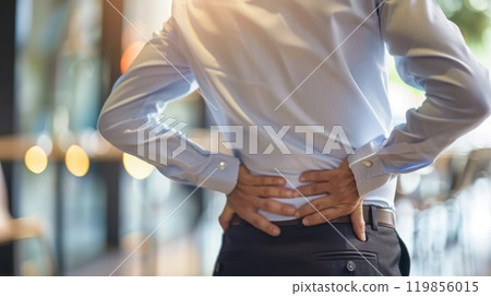 Office worker experiencing lower back pain, Poor posture can lead to back pain, backache, Lumbago Office worker experiencing lower back pain, Poor posture can lead to back pain, backache, Lumbago 119856015
