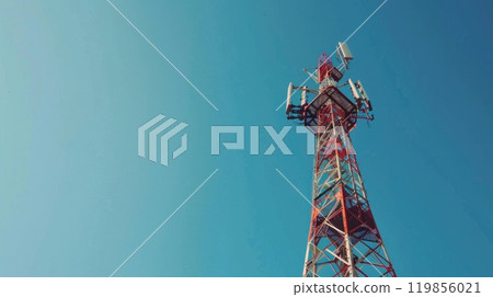 A tall modern communications tower, A signal modern tower with clear blue sky background A tall modern communications tower, A signal modern tower with clear blue sky background 119856021