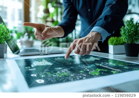 A man pointing at a computer screen with a green background A man pointing at a computer screen with a green background 119856029