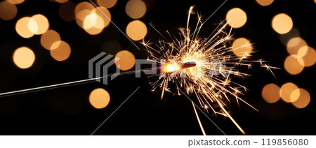 Glowing Sparklers in Sharp Focus Against a Dark Background 119856080