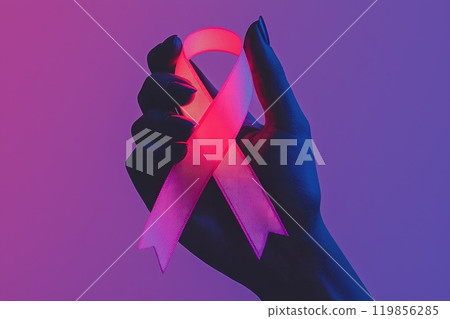 Glowing Pink Ribbon in a Hand Against a Colorful Background Glowing Pink Ribbon in a Hand Against a Colorful Background 119856285
