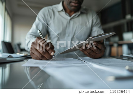 Recruiter Reviewing Documents with Clipboard in Office 119856434