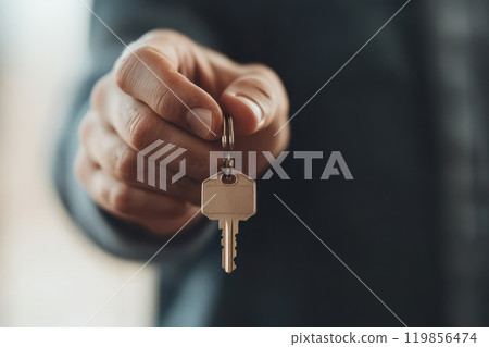 Happy Realtor Handing Over House Key to New Owner 119856474