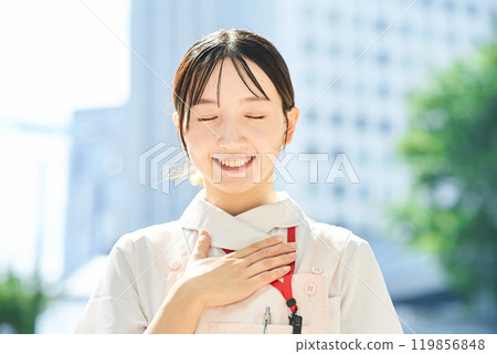 A woman in a white coat posing to give a sense of security 119856848