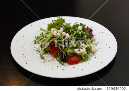Salad with feta cheese. Salad with cheese, tomatoes and herbs. Salad with feta cheese. Salad with cheese, tomatoes and herbs. 119856902