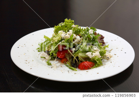 Salad with feta cheese. Salad with cheese, tomatoes and herbs. 119856903