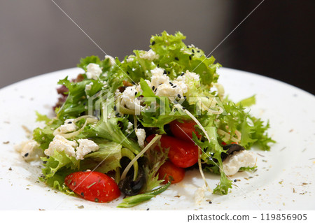 Salad with feta cheese. Salad with cheese, tomatoes and herbs. 119856905
