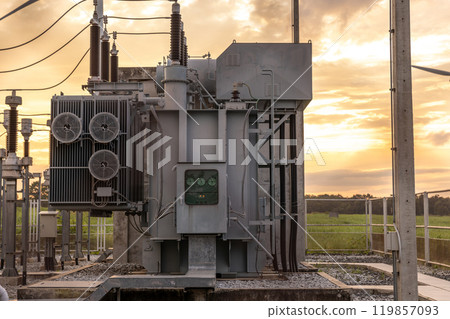 The transformer on a concrete pole. Three-phase transformers and rafts on rails for industrial plants. Transformer on concrete column beams. 119857093