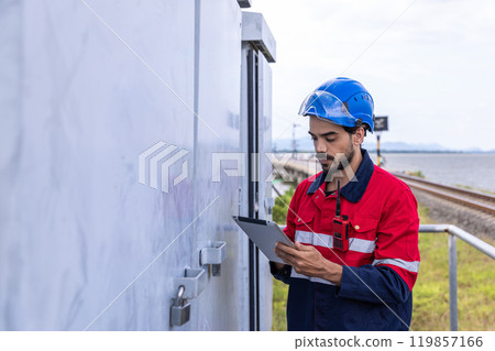 Electrical engineer man checking Power at Contruction Site. electrical engineer inspect the electrical systems at the equipment site Electrical engineer man checking Power at Contruction Site. electrical engineer inspect the electrical systems at the equipment site 119857166