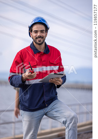 Electrical engineer man checking Power at Contruction Site. electrical engineer inspect the electrical systems at the equipment site 119857177