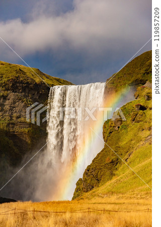Skogafoss waterfall and rainbow at sunny autumn day, Iceland. Great tourist attraction, Skogafoss waterfall and rainbow at sunny autumn day, Iceland. Great tourist attraction, 119857209