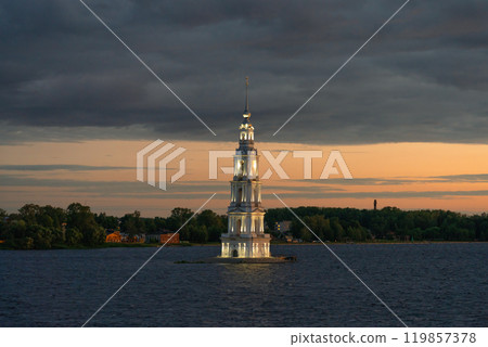 The Kalyazin bell tower is a flooded church illuminated at night against the background of sunset 119857378