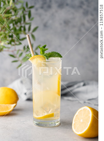Freshness mojito drink with lemon, mint and ice. Citrus lemonade on a blue background with napkin Freshness mojito drink with lemon, mint and ice. Citrus lemonade on a blue background with napkin 119857518