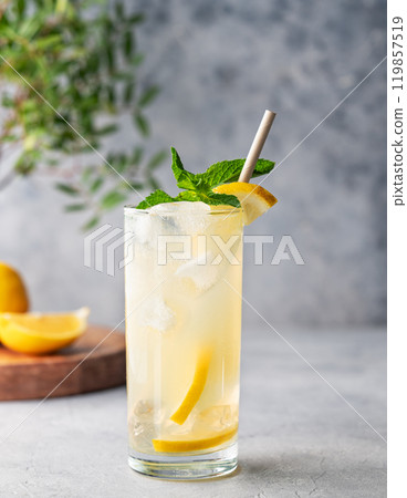 Freshness mojito drink with lemon, mint and ice. Citrus lemonade on a blue background  119857519