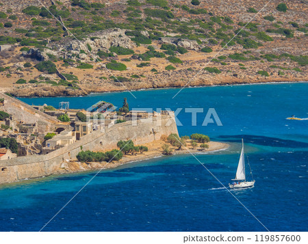 A yacht sails around the ruined island of Spinalonga (Crete, Greece) A yacht sails around the ruined island of Spinalonga (Crete, Greece) 119857600