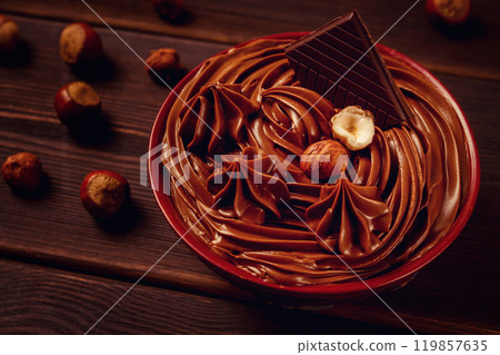 Chocolate nut paste, mousse, pasta, in a cup, on a wooden table, top view, selective focus, no people, Chocolate nut paste, mousse, pasta, in a cup, on a wooden table, top view, selective focus, no people, 119857635