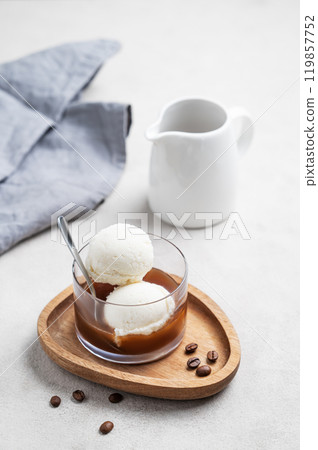Affogato coffee with vanilla ice cream scoops and  espresso in a glass on a wooden board  119857752
