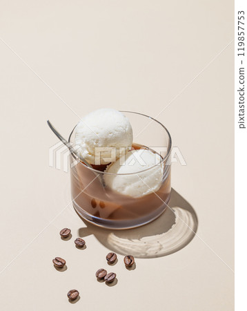 Affogato coffee with vanilla ice cream scoops and espresso in a glass on a yellow background Affogato coffee with vanilla ice cream scoops and espresso in a glass on a yellow background 119857753