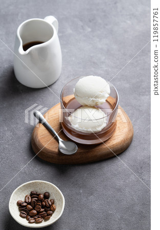 Affogato coffee with vanilla ice cream scoops and espresso in a glass on a wooden board Affogato coffee with vanilla ice cream scoops and espresso in a glass on a wooden board 119857761