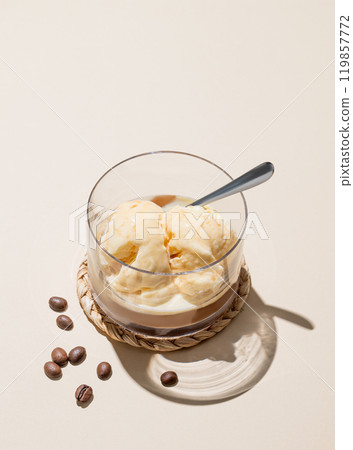 Affogato coffee with vanilla ice cream scoops and espresso in a glass on a light background  119857772