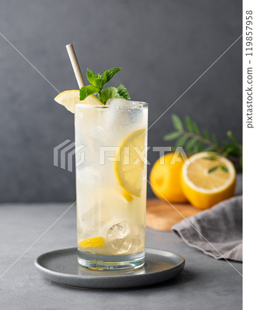 Freshness mojito drink with lemon, mint and ice. Citrus lemonade on a dark background Freshness mojito drink with lemon, mint and ice. Citrus lemonade on a dark background 119857958