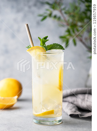 Freshness mojito drink with lemon, mint and ice. Citrus lemonade on a blue background Freshness mojito drink with lemon, mint and ice. Citrus lemonade on a blue background 119857959