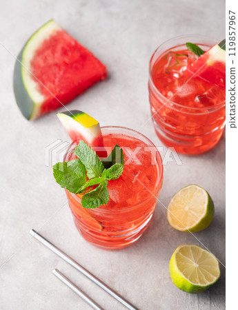 Mojito cocktail with watermelon, lime, ice and mint in a two glasses on a light background Mojito cocktail with watermelon, lime, ice and mint in a two glasses on a light background 119857967
