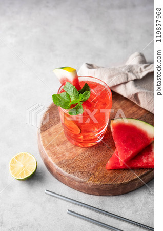 Mojito cocktail with watermelon, lime, ice and mint in a glass on a wooden board Mojito cocktail with watermelon, lime, ice and mint in a glass on a wooden board 119857968